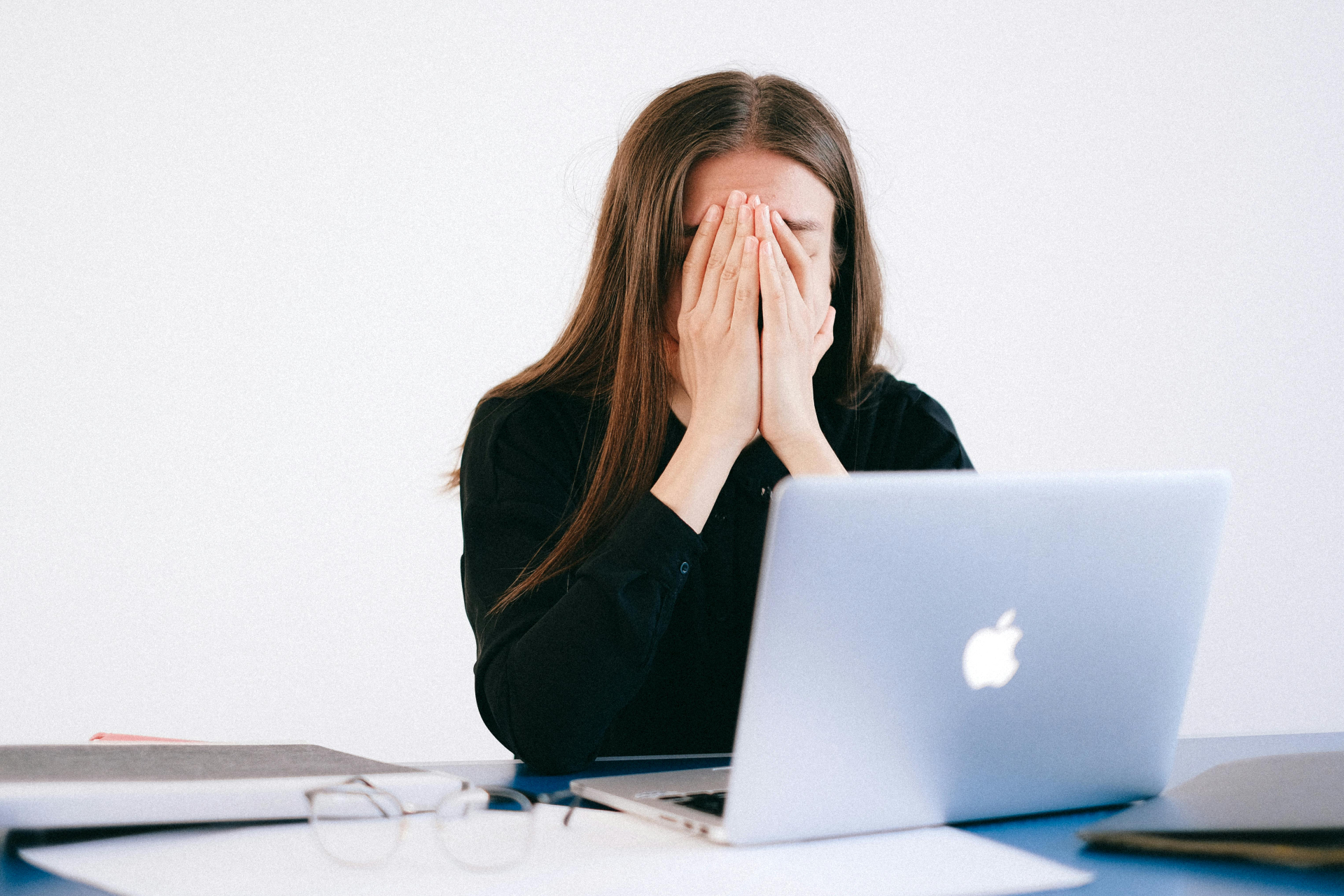 Gefrustreerde vrouw achter laptop die twijfelt over vaststellingsovereenkomst tekenen